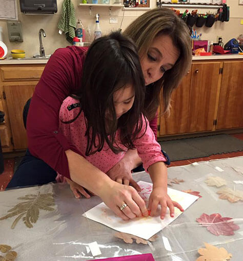 Teacher Shelly Helping Student with Arts and Crafts